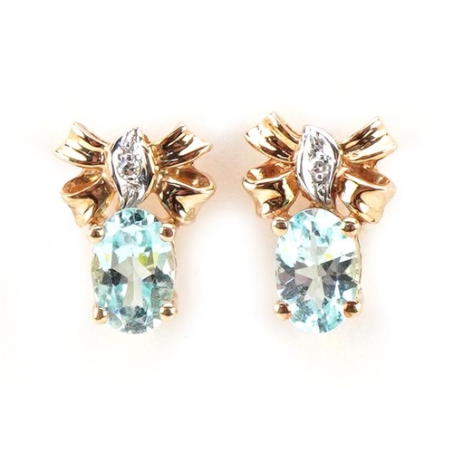 3510 - A pair of 9ct gold blue topaz and diamond bow design stud earrings, 10.5mm high, total 1.6g.