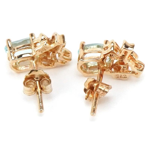 3510 - A pair of 9ct gold blue topaz and diamond bow design stud earrings, 10.5mm high, total 1.6g.