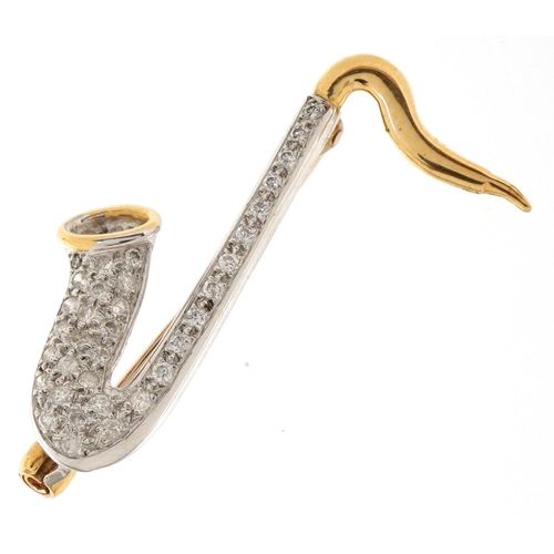 3167 - An 18ct two tone gold pavé set diamond brooch in the form of a saxophone, 3.2cm high, 3.1g.