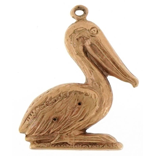 3228 - A 9ct gold charm in the form of a pelican, 1.9cm high, 0.7g.