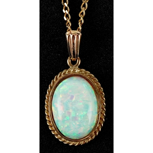 3143 - An unmarked gold cabochon opal pendant on a 9ct gold necklace, 2.5cm high and 46cm in length, total ... 