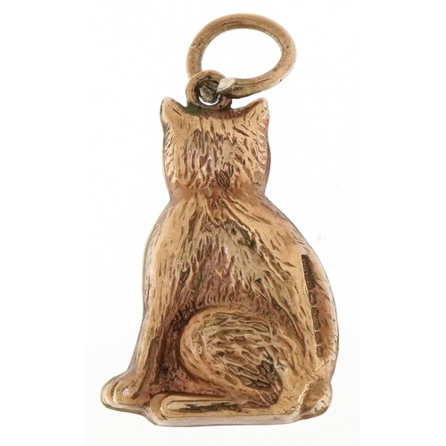 3088 - A 9ct gold charm in the form of a seated cat, 1.9cm high, 0.9g.