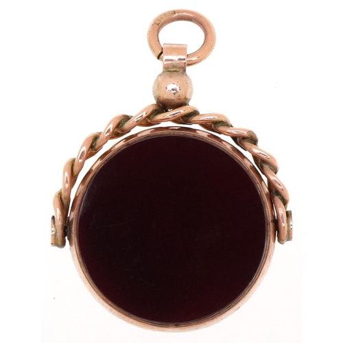 3213 - A Victorian 9ct rose gold carnelian and bloodstone spinner fob, Birmingham 1897, 3.0cm high, 8.4g.