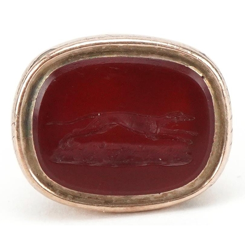 3036 - A Victorian yellow metal carnelian intaglio seal fob, the matrix engraved with a Greyhound, 2.3cm hi... 