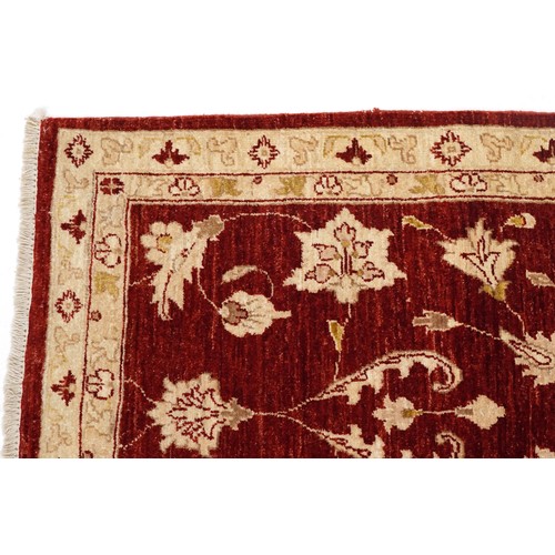 2009 - An Iranian Mashhad rug, 20th century, with allover flower head design within a complementary border,... 