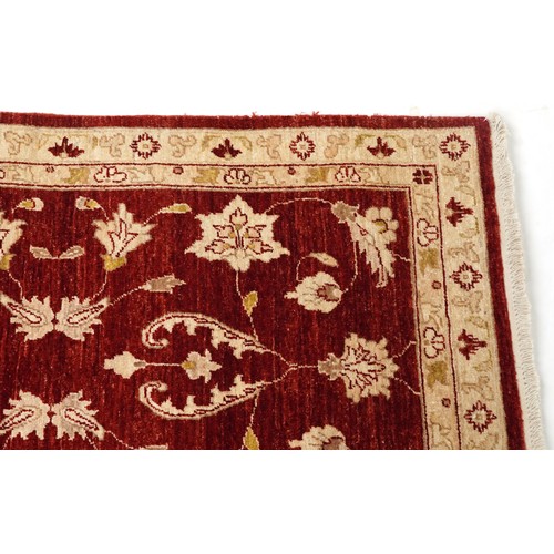 2009 - An Iranian Mashhad rug, 20th century, with allover flower head design within a complementary border,... 