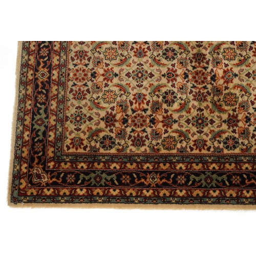 2007 - An Afghan Ziegler rug, late 20th century, the red field with stylized flower head design within a co... 