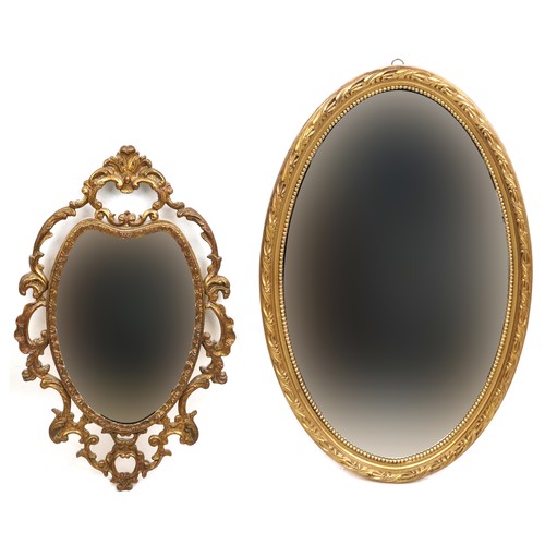 2048 - A late 20th century gilt framed oval wall mirror, 63cm x 41cm, together with a Rococo style gilt ova... 