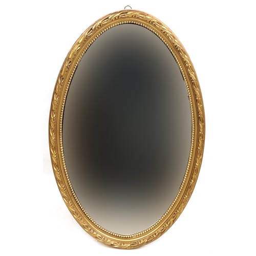 2048 - A late 20th century gilt framed oval wall mirror, 63cm x 41cm, together with a Rococo style gilt ova... 