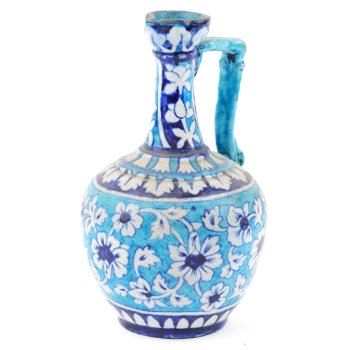 113 - A Turkish Ottoman Iznik salt glazed pottery jug, late 19th/early 20th century with under glaze hand ... 