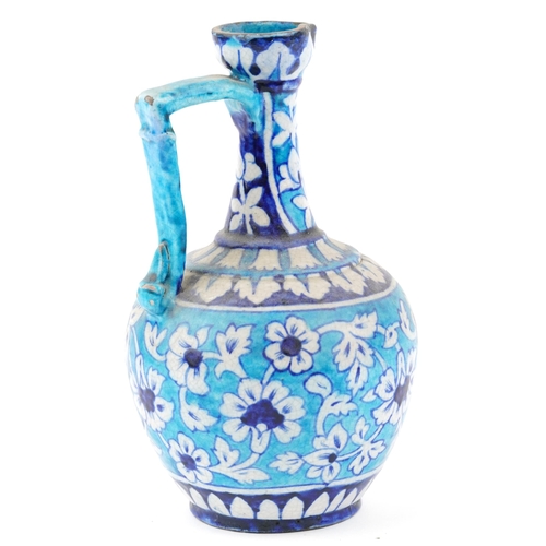 113 - A Turkish Ottoman Iznik salt glazed pottery jug, late 19th/early 20th century with under glaze hand ... 