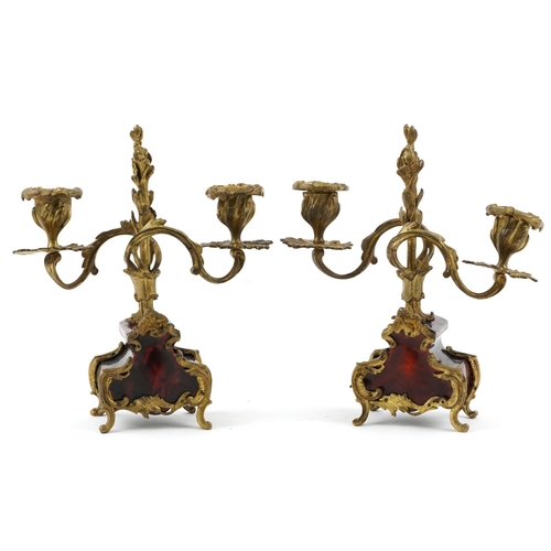 162 - A pair of late 19th century ormolu and tortoiseshell twin branch candlesticks with foliate decoratio... 