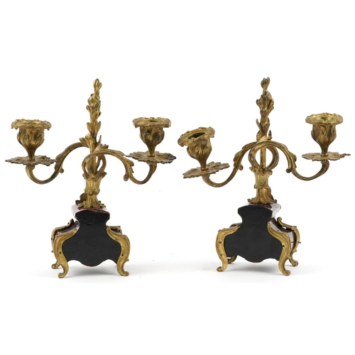 162 - A pair of late 19th century ormolu and tortoiseshell twin branch candlesticks with foliate decoratio... 