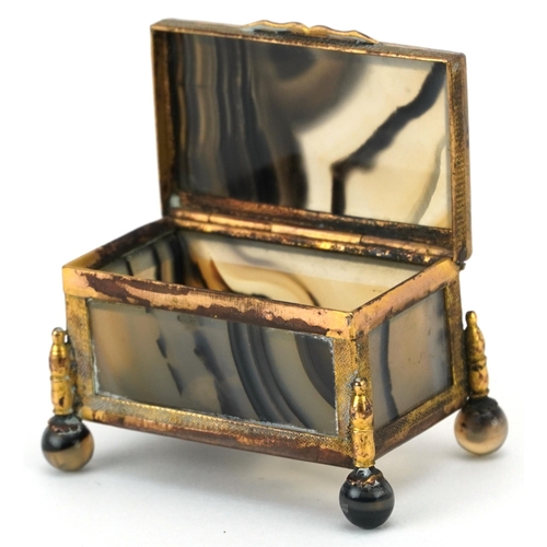 125 - A late 19th century French agate and ormolu mounted diminutive casket, with hinged lid, raised on ba... 