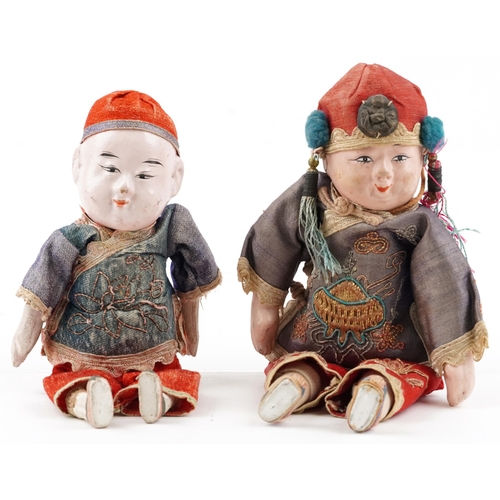 419 - Two similar Chinese dolls, early 20th century, each with embroidered decoration and hand painted fac... 