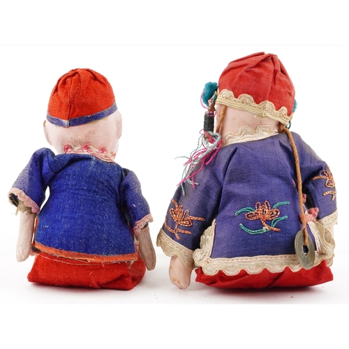 419 - Two similar Chinese dolls, early 20th century, each with embroidered decoration and hand painted fac... 