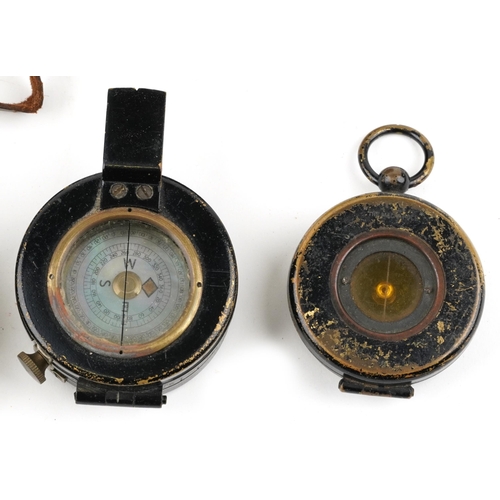 2427 - A group of four 20th century military compasses, two with leather cases.