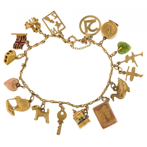 3003 - A 9ct gold charm bracelet with a collection of mostly gold charms including a kiwi, enamelled tankar... 