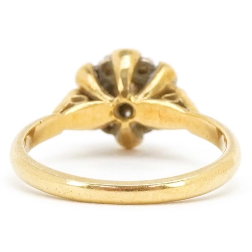 3498 - An 18ct gold diamond flower head ring with ornate setting, size L, 3.6g.