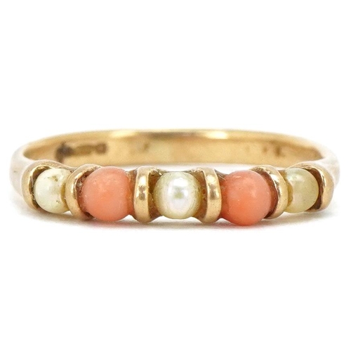 3495 - A 9ct gold coral and seed pearl half eternity ring, size I, 1.4g.