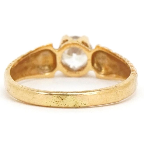 3174 - An 18ct gold clear stone solitaire ring with engraved shoulders, size M, 2.5g.