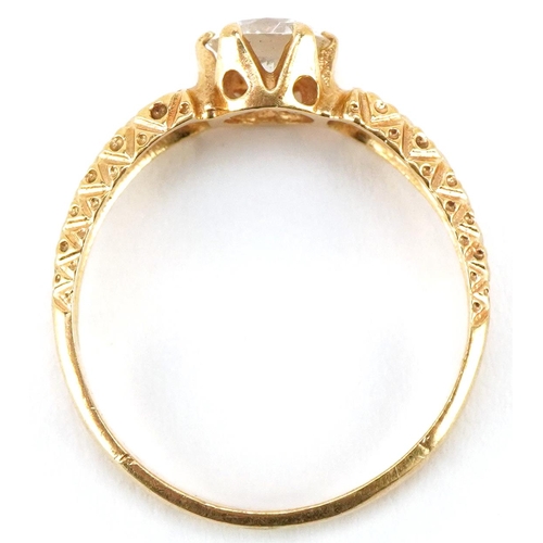 3174 - An 18ct gold clear stone solitaire ring with engraved shoulders, size M, 2.5g.