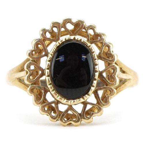 3218 - A 9ct gold black onyx ring with pierced love heart setting, size O/P, 1.9g.