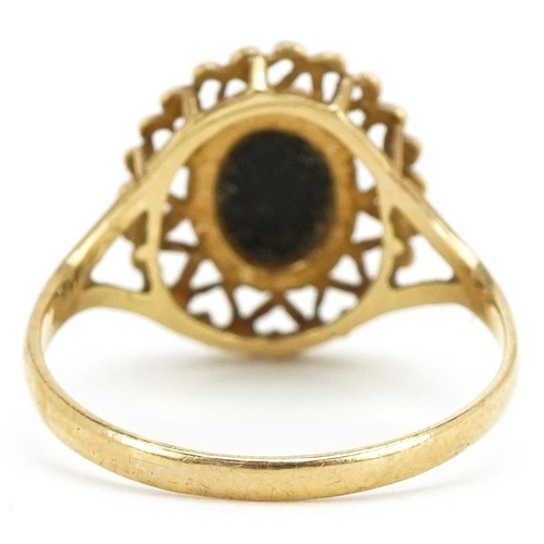 3218 - A 9ct gold black onyx ring with pierced love heart setting, size O/P, 1.9g.