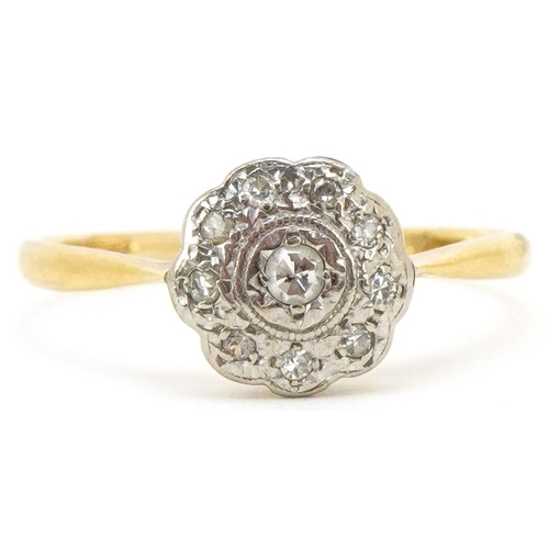 3211 - An 18ct gold and platinum diamond flower head ring, size U, 2.5g.