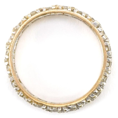 3480 - A 9ct two tone gold clear stone eternity ring, size M, 2.6g.