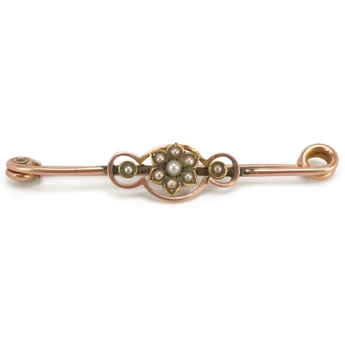 3129 - An antique unmarked gold seed pearl bar brooch, 4cm wide, 1.5g.