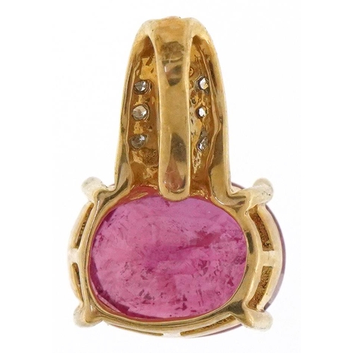 3199 - A 9ct gold ruby and diamond pendant, the ruby approximately 12.35mm x 9.45mm x 6.70mm deep, overall ... 