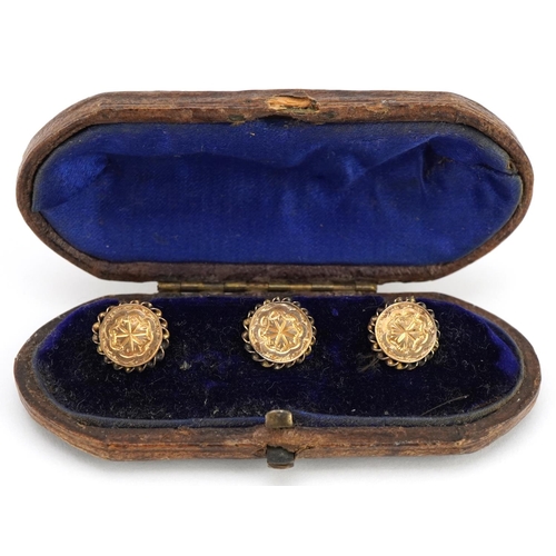 3201 - A set of three Victorian unmarked gold gentlemen's dress studs housed in a velvet and silk lined fit... 