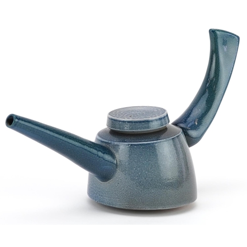 64 - A mid 20th century salt glazed studio pottery teapot by Jeremy Nichols, 28cm in length.