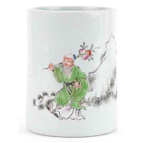 298 - A Chinese porcelain cylindrical brush pot hand painted with an elder with fruit before mountains and... 