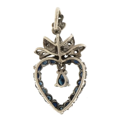 3107 - A vintage unmarked silver love heart pendant set with sapphires and clear stones, 3.5cm high, 4.4g.