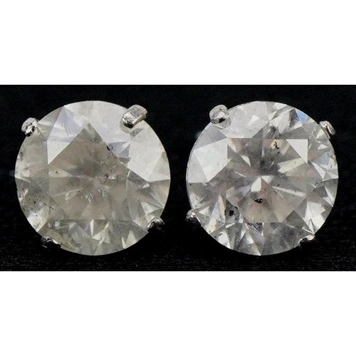 3005 - A pair of 18ct white gold diamond solitaire earrings, total diamond weight approximately 1.7carat