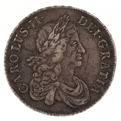 2201 - A Charles II 1671 silver crown with raised lettering to the edge.