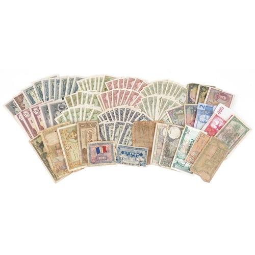 2215 - A quantity of vintage world banknotes to include Japanese Occupational Governmental banknotes of Mal... 