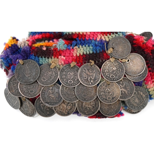 2207 - A mid 19th century Peruvian hand crocheted miser's purse with approximately fifty drilled silver coi... 