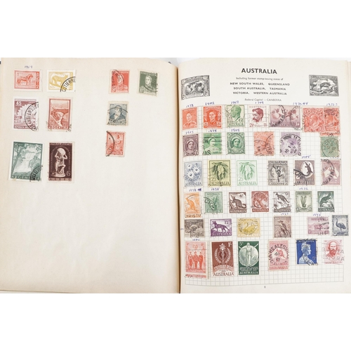 2220A - Two blue stamp albums containing 19th century and later British and world stamps.