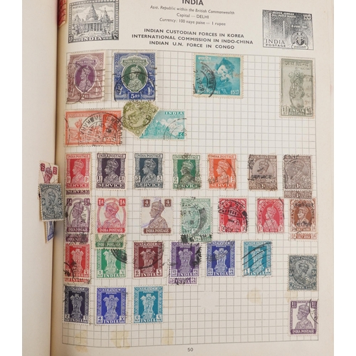 2220A - Two blue stamp albums containing 19th century and later British and world stamps.