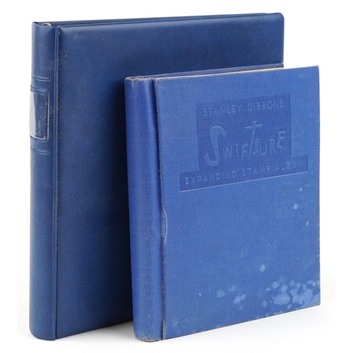 2220A - Two blue stamp albums containing 19th century and later British and world stamps.