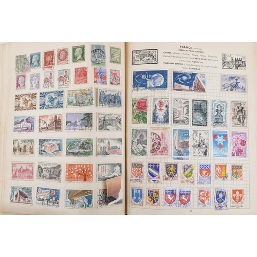 2220A - Two blue stamp albums containing 19th century and later British and world stamps.