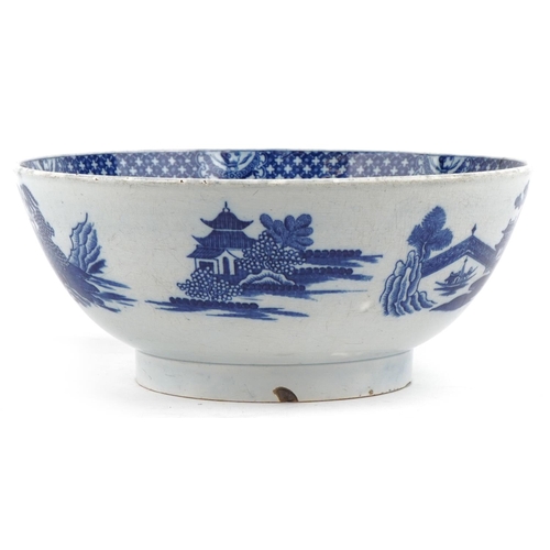 117 - A 19th century English porcelain blue and white transfer printed Willow pattern bowl, 24cm in diamet... 