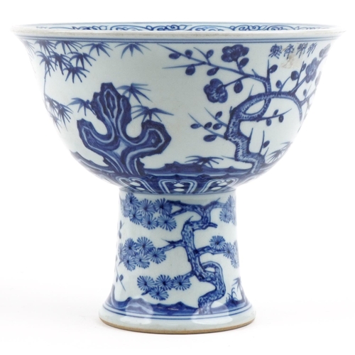 112 - A 20th century Chinese porcelain blue and white stem bowl hand painted with cherry blossom and bambo... 