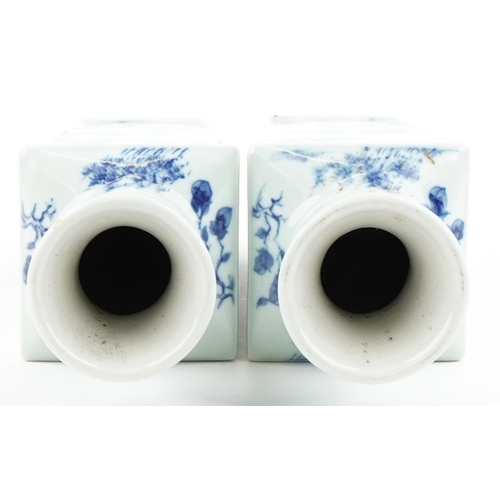 34 - A pair of Chinese porcelain blue and white flat sided vases hand painted with figures amongst mounta... 