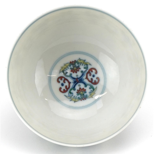 187 - A 20th century Chinese porcelain footed bowl hand painted with stylized flowers, six figure characte... 