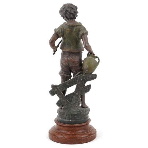 488 - After R F Moreau, a spelter study of a young boy with water jug raised on a turned wooden base, 46cm... 