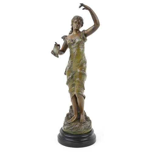 487 - After Besombes, a spelter study of an Art Nouveau female holding a script, raised on an ebonised bas... 